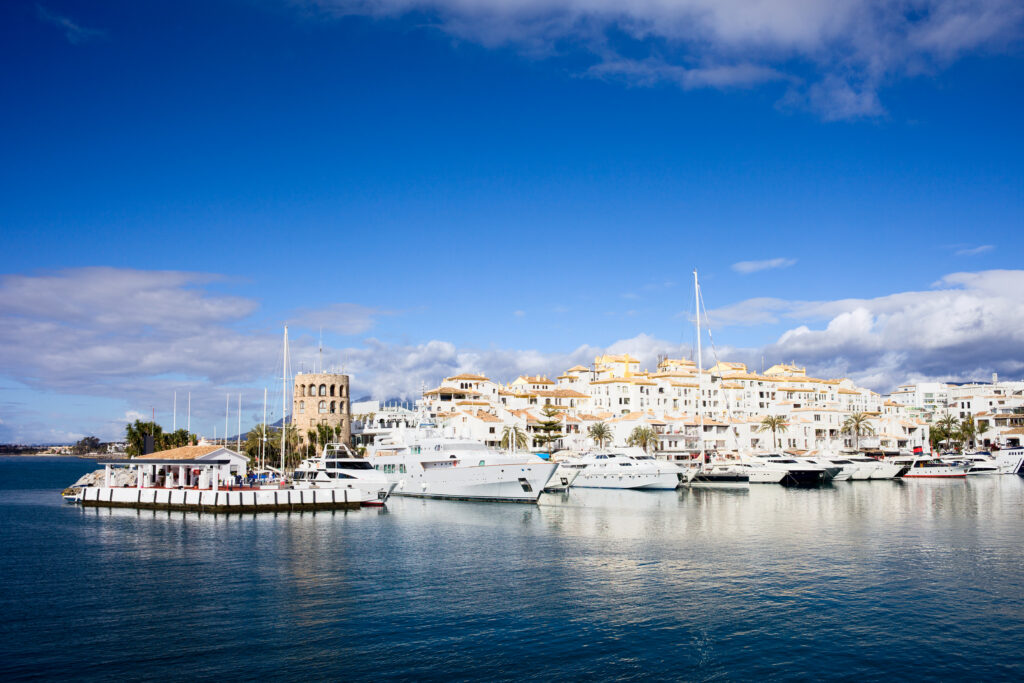 Stunning views of boats and a tower in the harbour of Puerto Banus
