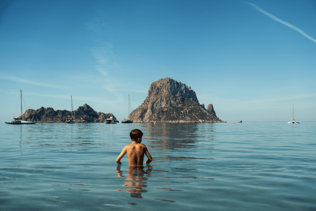 child in sea looking at es vedra