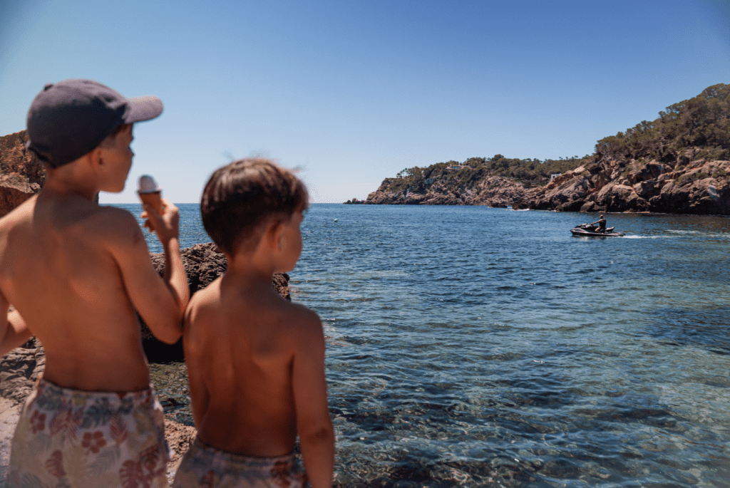 boys looking out to sea eating ice cream