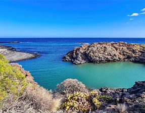 image of a bay called playa barranco, small inlet cove and black volcanic rocks