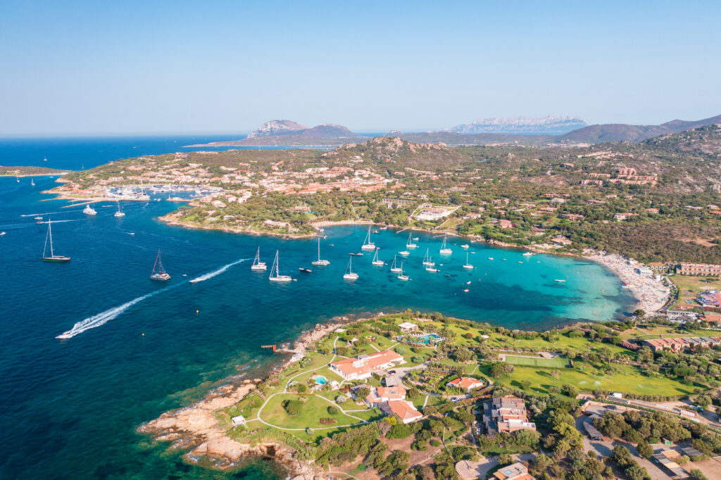 Aerial view of Porto Rotondo bay with sailboats and turquoise water, Olbia, Sardinia, Italy